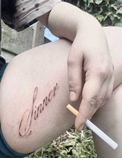 Fineline script tattoo leg